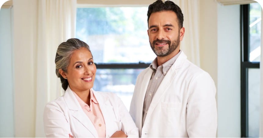 Two audiologists standing side by side.